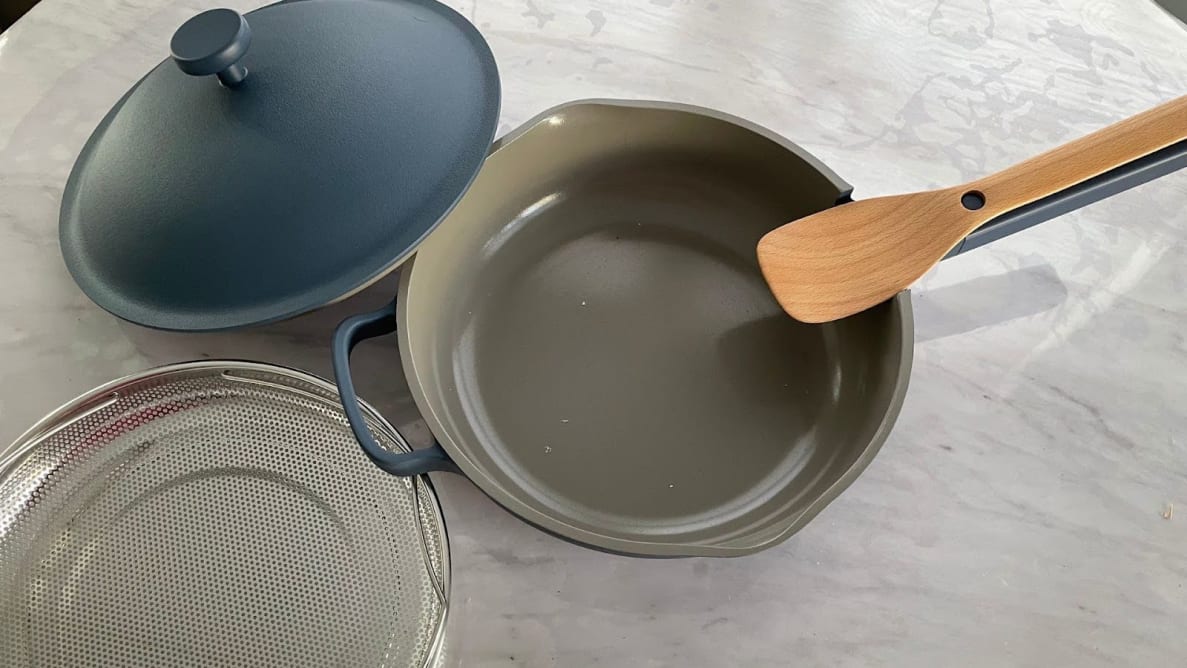 The Always Pan 2.0 with accompanying pan, lid, steamer basket/colander, and spatula.