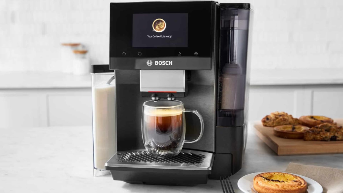 Bosch espresso machine on a kitchen counter with a prepared coffee mug inside.