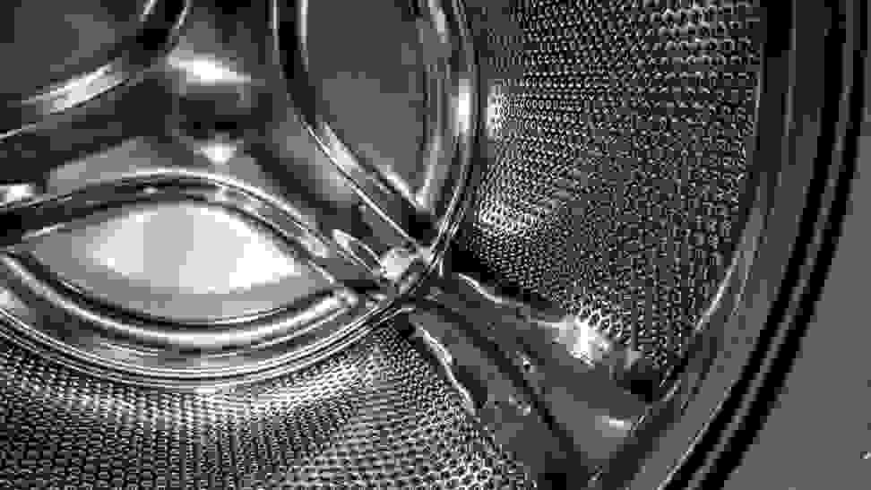 A close-up detail of a stainless steel washing machine drum