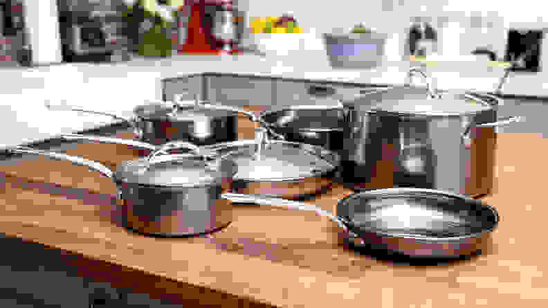 Pots and pans from the Hestan NanoBond 10-piece cookware set sit on a kitchen counter.