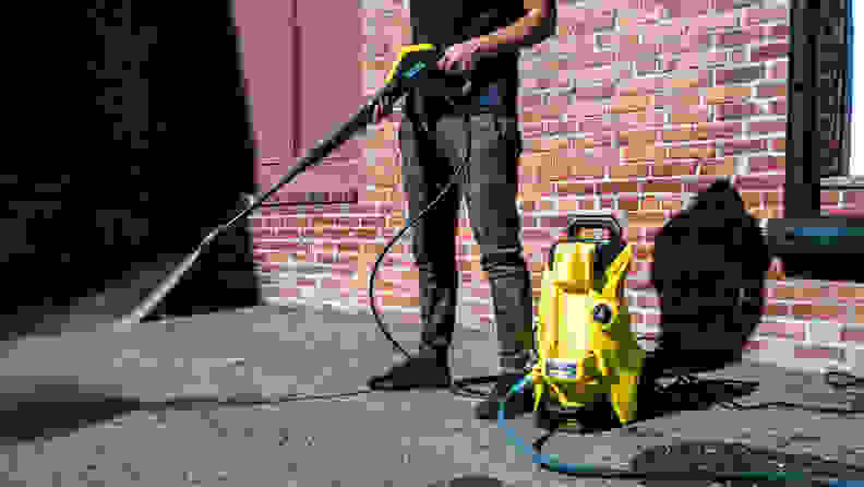 The Karcher K4 Power Control pressure washer is shown cleaning asphalt.