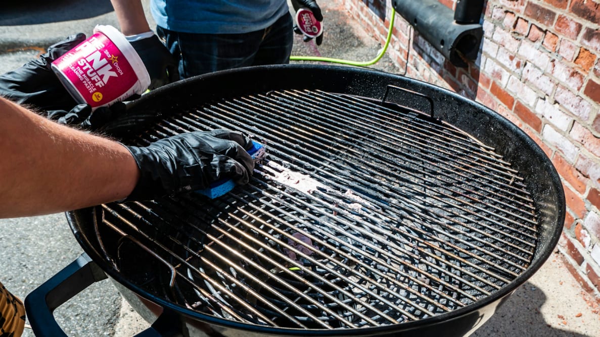 The Pink Stuff all-purpose cleaner is applied to a grill by hand.