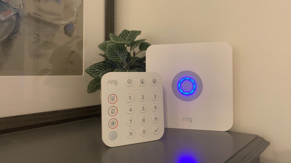 The Ring Alarm System keypad and home base station sit on a grey stand.