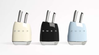 Three pastel retro-style Smeg knife block sets arranged in a row.