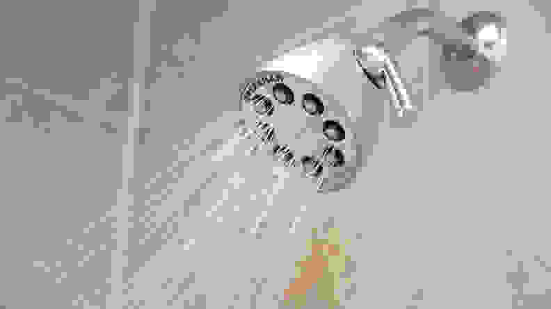 The Speakman S-2251 silver shower head shown spraying water.