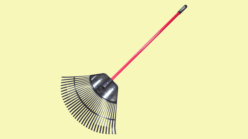 A wide tined Bully Tools leaf rake on a yellow background.