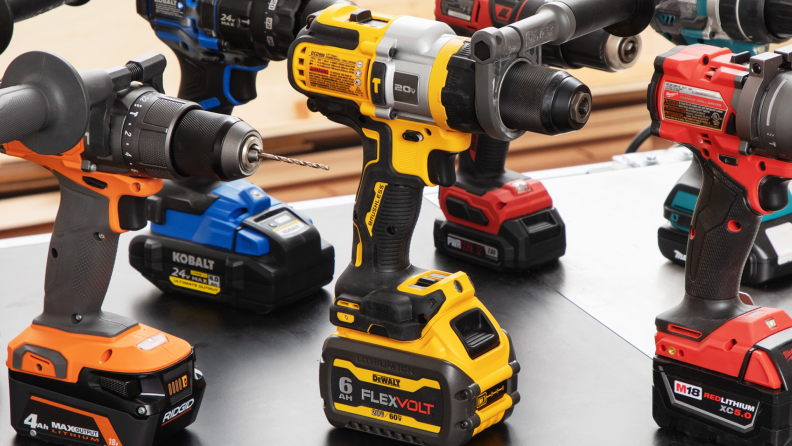 A closer view at the Dewalt 20V Max hammer drill next to other drills.