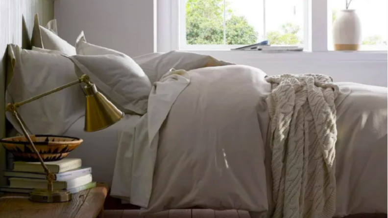 An image of a set of gray flannel sheets from the Company Store arranged on a bed.