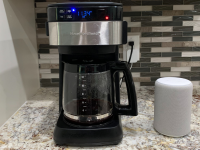 Hamilton Beach's smart coffee maker sits next to an Amazon Echo speaker on the kitchen counter.