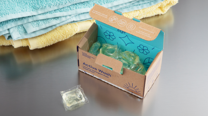 A package of eco-friendly laundry pods on a washing machine.