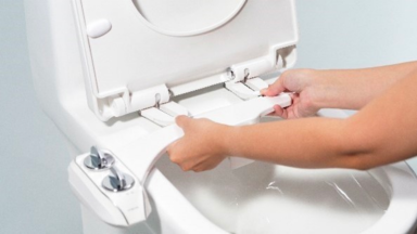 An image of a Neo 320 Plus bidet from Luxe Bidets being fitted into a toilet seat.