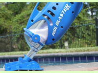 Water tech pool blaster pool vacuum next to an in-ground pool