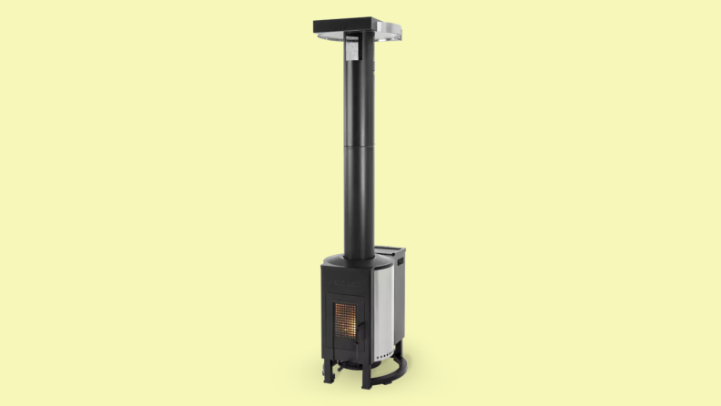 A long piped Solo Stove pellet burning Tower Patio Heater sits on a yellow background.