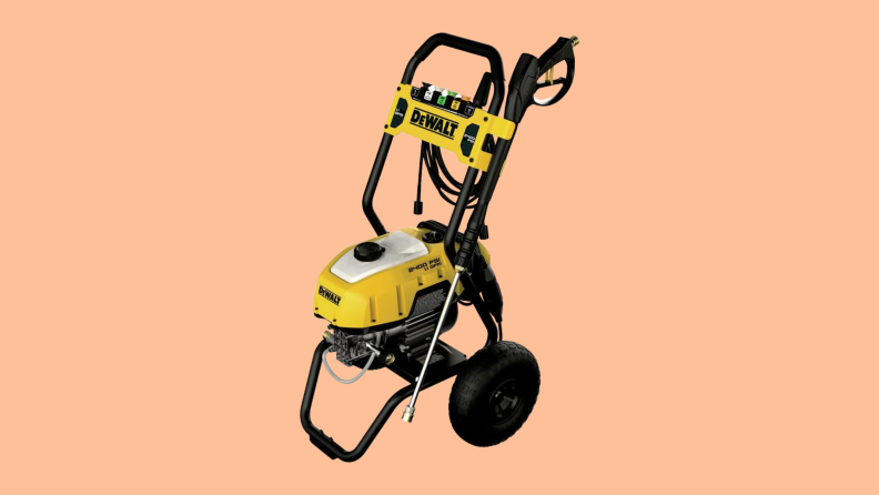 A DeWalt DWPW2400 pressure washer sits on a peach colored background.