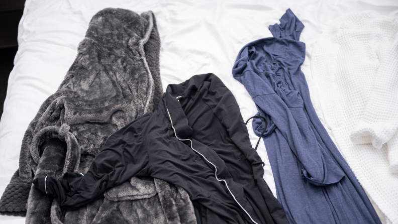 Robes lying on a bed.