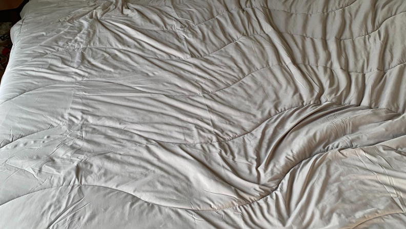 Rest comforter is shown with wrinkles.